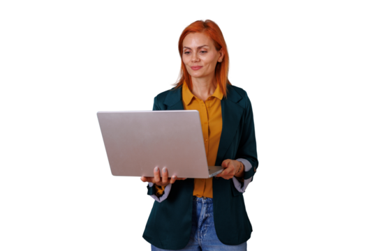 Businesswoman with red hair holding an open laptop, looking at the screen and working. Isolated on transparent background