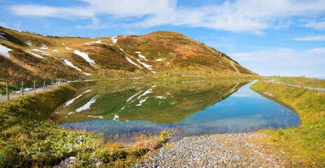 Lake Riezler Alpsee with water reflection at early springtime. landscape Oberstdorf allgau alps