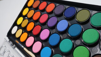 Palette of colorful eyeshadow for make-up on white background