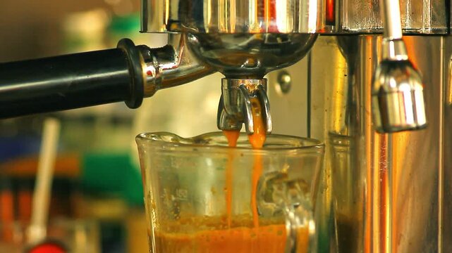 Brewing famous Thai red tea into a glass in a cafe
