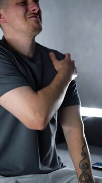 A man massages his sore shoulder with his hand.
A man massages his sore arm and is overcome with intense pain.
Pain due to arm injuries.
Arm, body, pain, arthritis: impact, bruise