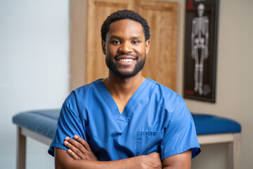 Smiling male healthcare professional in blue scrubs, showcasing confidence