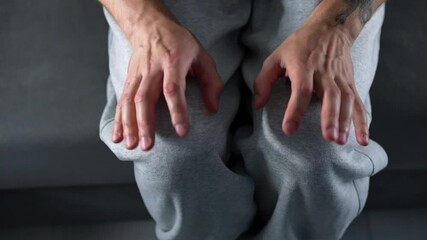 A man is shaking his legs in anxiety.
A man in gray pants is experiencing leg tremors and severe stress.
The man is experiencing fear and anxiety.
Knees, fear, tremors, anxiety, overexertion