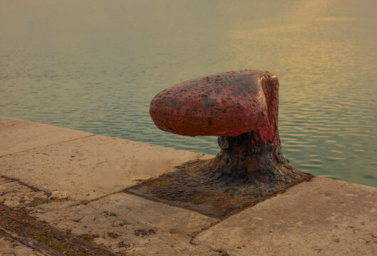 Bita  con cabo de amarre, para barcos en un muelle de un puerto mar&iacute;timo
