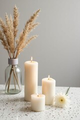 Cozy Minimalist Candle Arrangement with Dried Flowers and Warm Light