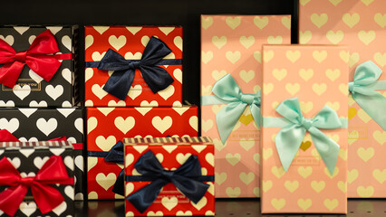 Colorful gift boxes with heart patterns and decorative bows