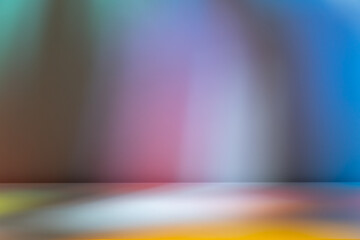 Abstract colorful blurred light on wall and table. Stained glass light.
