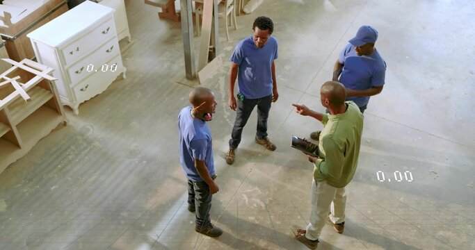 Discussing plans carpentry crew holding tablet and wearing boots in carpentry shop, with planks - Powered by Adobe