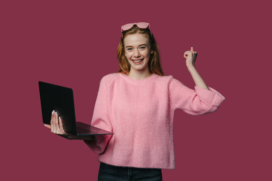 confident woman demonstrates concept, professional woman in pink sweater shares creative workflow