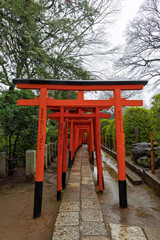 Scenic view of red torii gate in Yanaka subsurb in Tokyo, Japan. Yanaka is an atmospheric, traditional part of Tokyo known for its nostalgic atmosphere, temples and cats.