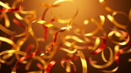 Video of festive gold and red ribbons floating slowly. Shiny streamers twirl against a warm, glowing background. Celebration and holiday party concept - Powered by Adobe