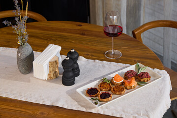 An Elegant Dining Table with Gourmet Food and Fine Wine offers a luxurious hosting experience