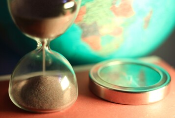 The hourglass and the compass and the globe symbols of time and travelling

