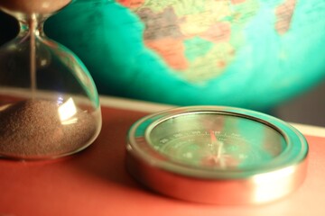 The hourglass and the compass and the globe symbols of time and travelling
