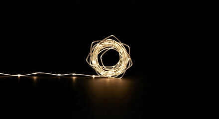 
Illuminated wire loop with decorative lights on a black background