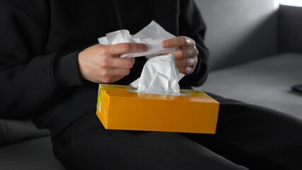 A person holding a large yellow package of wipes.
Paper wipes for health and skin care.
Antibacterial wipes in the hands of a person sitting on a sofa.