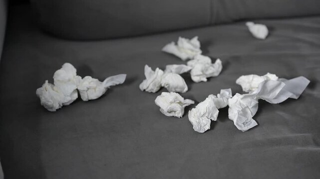 A close-up of wrinkled paper napkins.
A person used the paper napkins and scattered them around the room.
Paper trash in the office