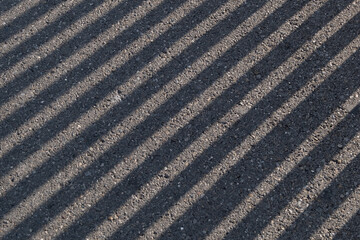 Fototapeta premium A black and white photo of a road with a lot of shadows
