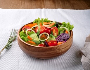 fresh vegetable salad with colorful ingredients served in a wooden bowl on a white tablecloth