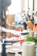A person meticulously slices and layers tomatoes and mozzarella in a bright kitchen, creating an appetizing Caprese salad on a plate. Morning light streams through the window
