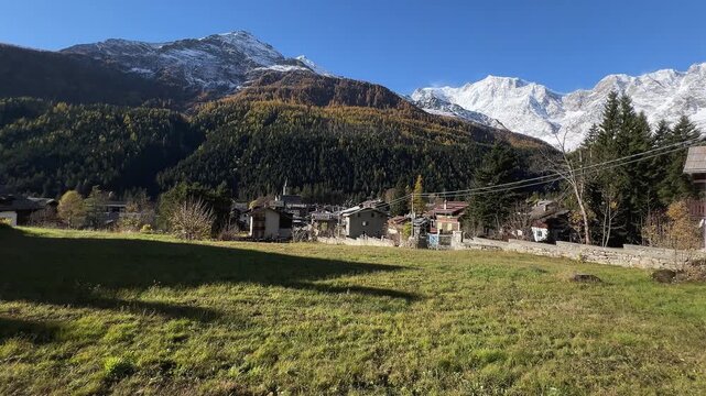 Macugnaga, Italy. Important summer and winter tourist village in the european Alps. Landscape of Macugnaga with Monte Rosa in autumn. Pan