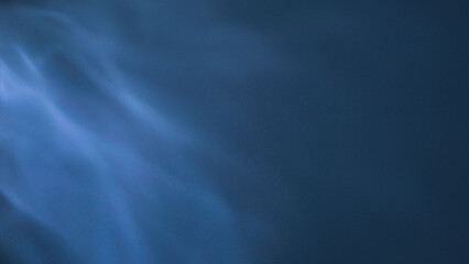 Abstract Blue Light: An ethereal display of blue light dances across a dark canvas, evoking a sense of mystery, depth, and the unknown. A visual exploration of light and shade.