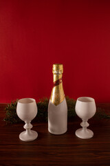 Christmas atmosphere with a bottle of sparkling wine and two white crystal glasses