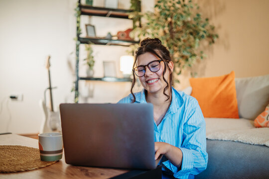 Young caucasian woman work on laptop or video call from home	
