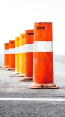 Road construction barriers displayed in a row at a work site during daytime with bright lighting and clear weather with white background