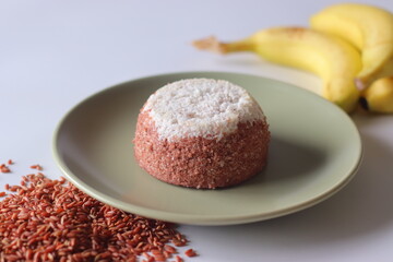 Navara rice puttu. Dome shaped steamed rice cake with Navara rice grains and grated coconut topping