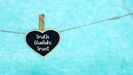 TRUTH BUILDS TRUTH writing concept on a mini whiteboard.
