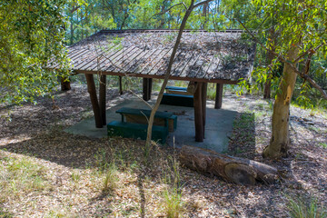 Photograph of an old semi abandoned wooden picnic shelter located in a forest in the Blue Mountains, NSW, Australia.