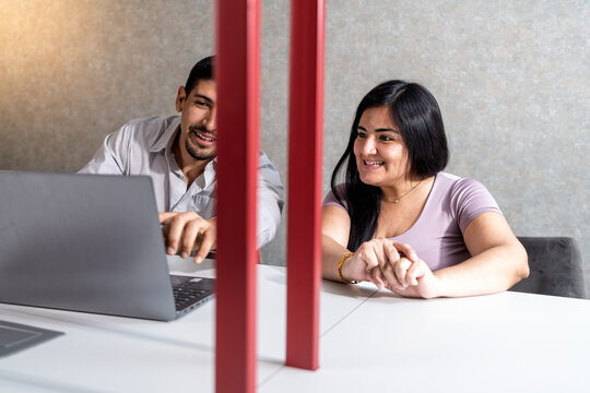Employee assisting customer with computer in office