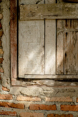 The sunlight shone through the worn wooden window.