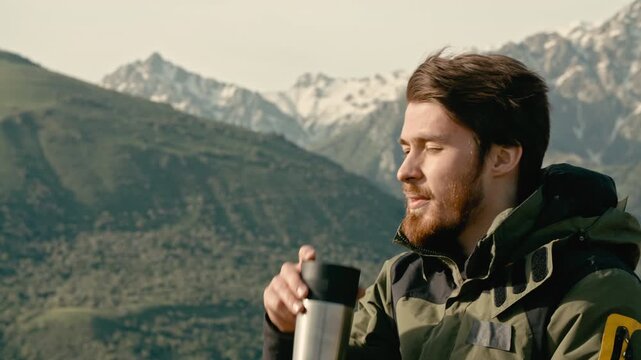 Bearded man traveler smiling drinking hot tea with copy space concept of happiness mindfulness outdoor freedom peace slow life simplicity and self care natural light warm morning