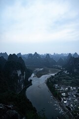Mountain view overlooking river and valley with forest and clouds