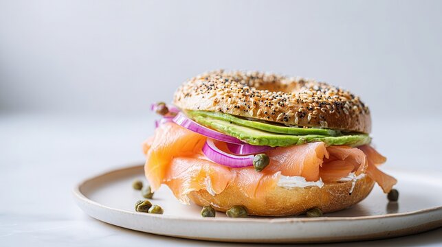 Everything Bagel With Cream Cheese, Lox, Avocado, Red Onion, and Capers on Plate
