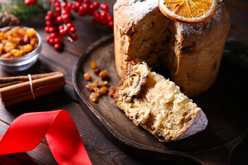 Christmas food. Delicious Panettone cake and festive decor on wooden table, closeup