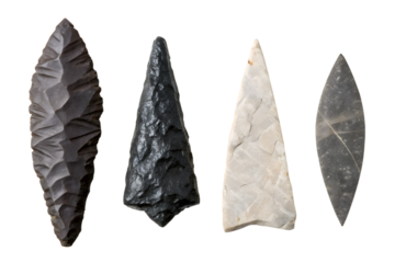 Diverse collection of authentic prehistoric stone tools, meticulously crafted arrowheads and spear points, showcasing ancient human ingenuity and survival technology