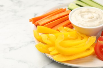 Different fresh vegetables and sauce on white marble table, closeup. Space for text