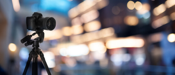 Professional camera on tripod against blurred background. Banner design © New Africa