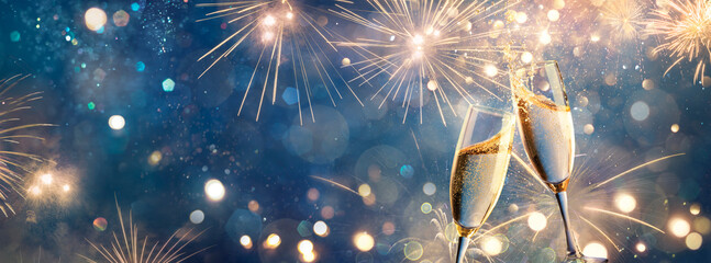 Champagne Toast - Happy New Year - Flutes With Golden Fireworks In Abstract Night With Defocused Bokeh Lights for Anniversary Celebration