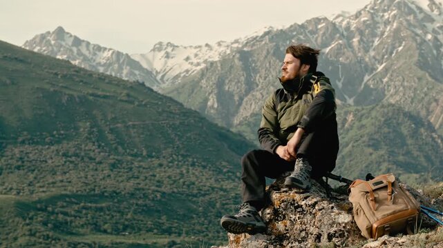 Traveler man sitting on mountain top with copy space concept of freedom achievement mindfulness travel adventure lifestyle success and peaceful mind in nature outdoor exploration and inspiration