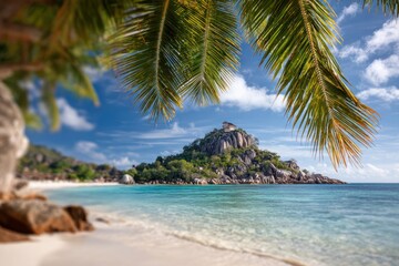 Tropical beach scene with palms, turquoise water, white sand, rocky island and clear blue sky