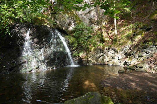 The waterfall at The Fairy Glen, Rosemarkie, Inverness, Scotland, in dappled sunlight. 