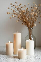 Elegant composition of white candles and dried flowers in soft natural lighting. Aesthetic home decor scene perfect for relaxation, hygge lifestyle, and minimalist interior inspiration