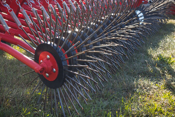 Part of agricultural rotary harrow on cultivated field. Modern technology in agriculture