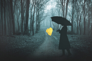 Autumn forest in fog and a single golden leaf.