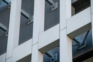 Bird control metal spikes mounted on  a  modern office building. Anti pigeon spikes.