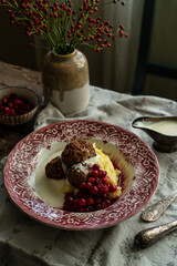 Traditional Swedish meatballs with mashed potatoes, cranberries and creamy gravy in vintage plate on wooden table. Homemade dinner. Comfort food.